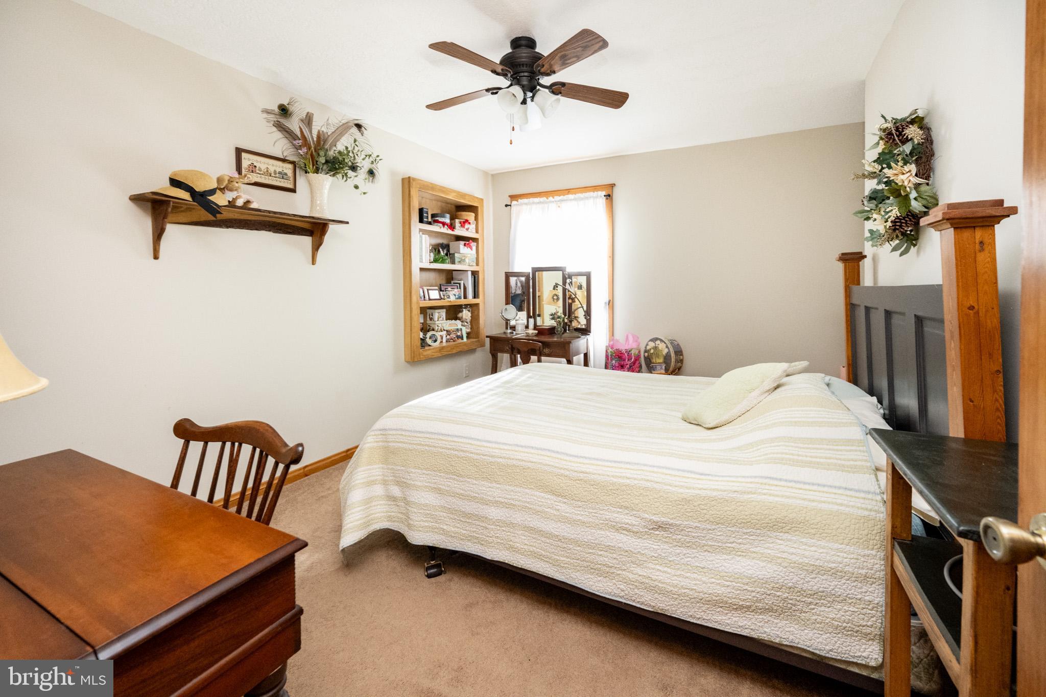 328 Stool Rock Road Oakland, MD 21550 - Photo 49 of 117 a bedroom with a bed and a chandelier