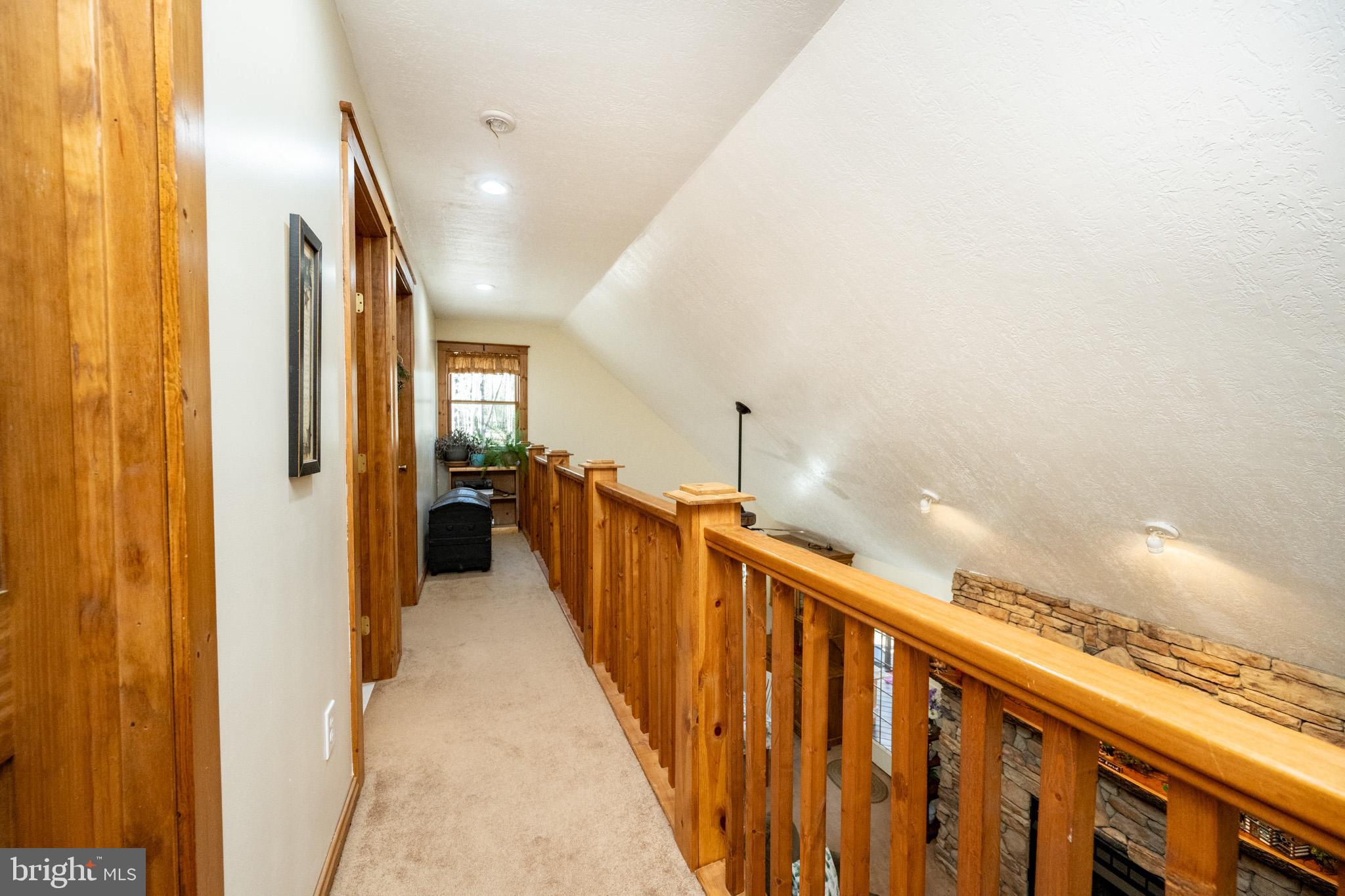 328 Stool Rock Road Oakland, MD 21550 - Photo 67 of 123 a view of a hallway with wooden floor and staircase
