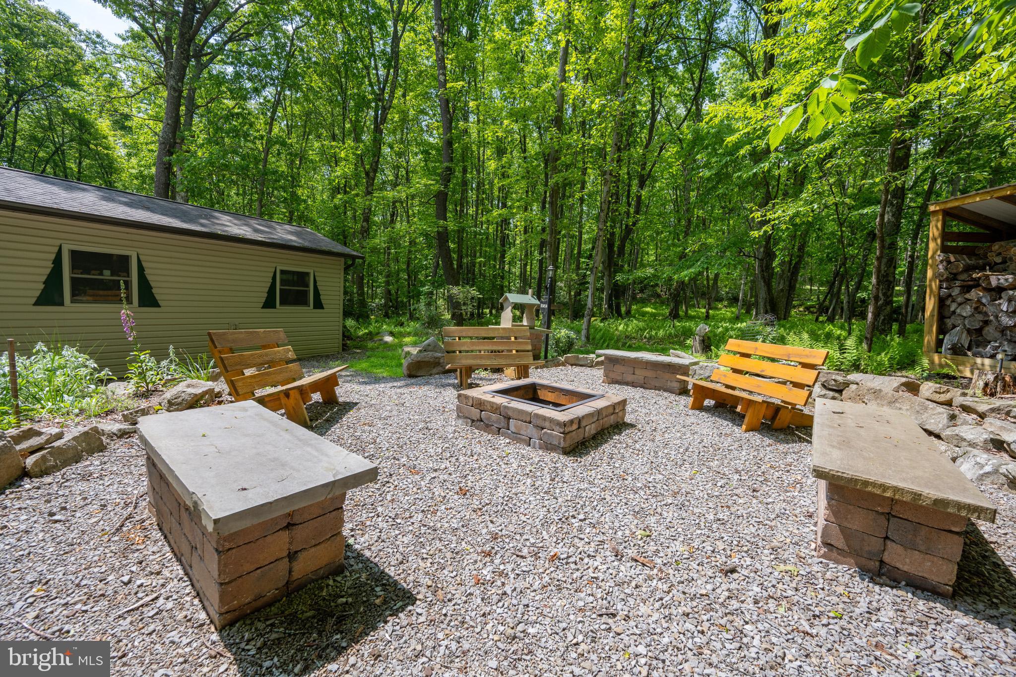 328 Stool Rock Road Oakland, MD 21550 - Photo 87 of 123 a backyard of a house with outdoor seating