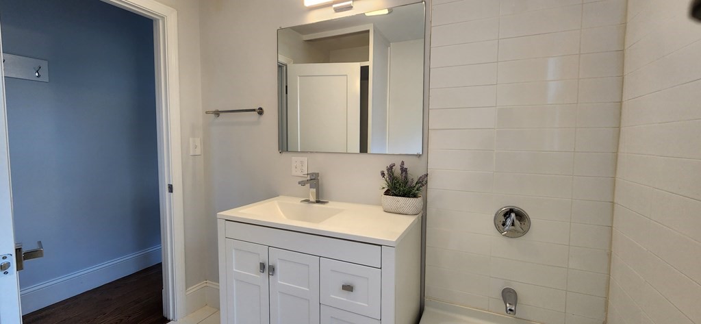 38 Kimball Road, Unit 2 Watertown, MA 02472 - Photo 11 of 29 a bathroom with a sink a vanity and a mirror