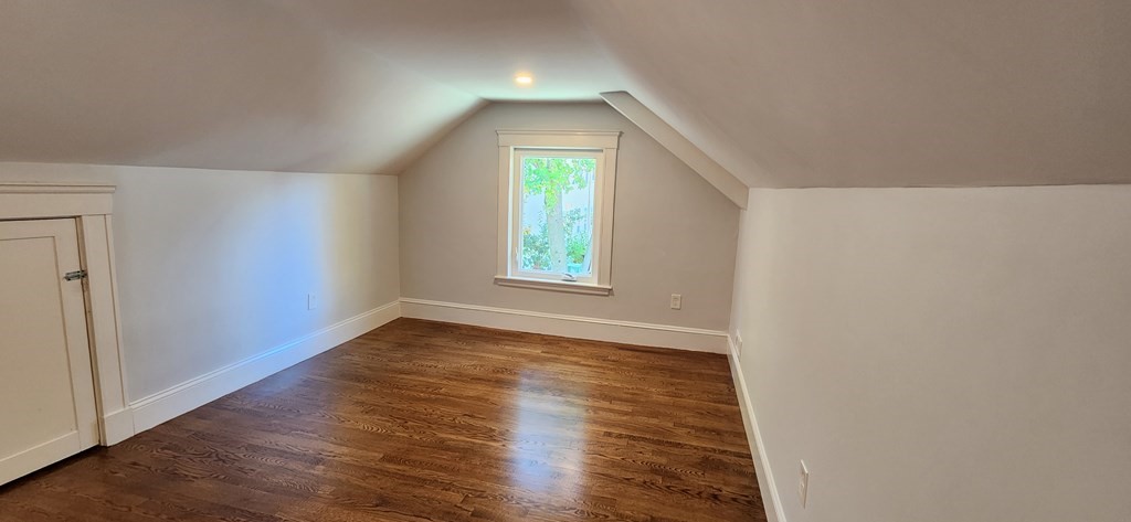 38 Kimball Road, Unit 2 Watertown, MA 02472 - Photo 14 of 29 an empty room with wooden floor and windows