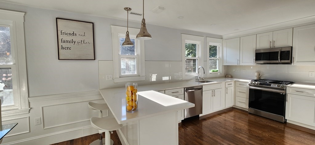 38 Kimball Road, Unit 2 Watertown, MA 02472 - Photo 6 of 29 a kitchen with stainless steel appliances granite countertop a stove a sink and a refrigerator