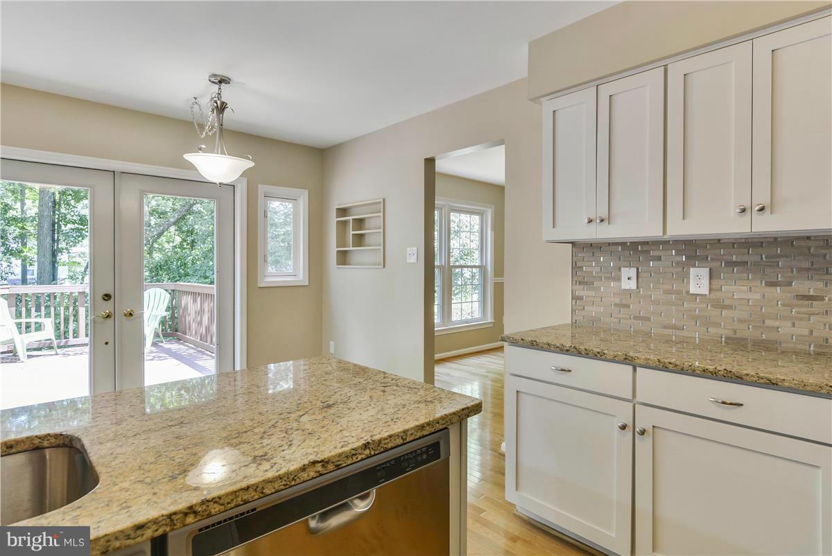 15212 Philip Lee Road Chantilly, VA 20151 - Photo 6 of 30 a kitchen with granite countertop a sink a stove and cabinets