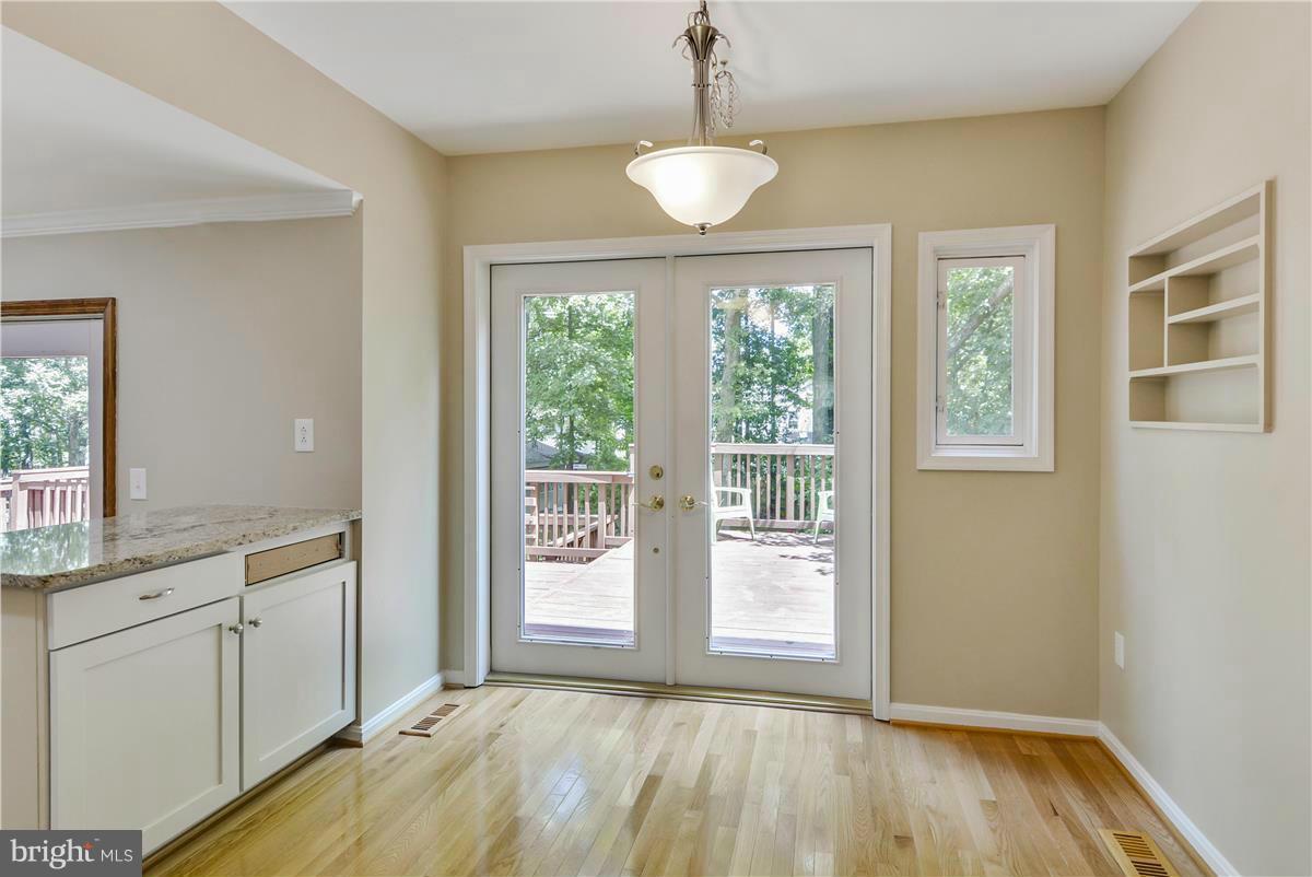 15212 Philip Lee Road Chantilly, VA 20151 - Photo 7 of 30 a view of an empty room with a window and wooden floor