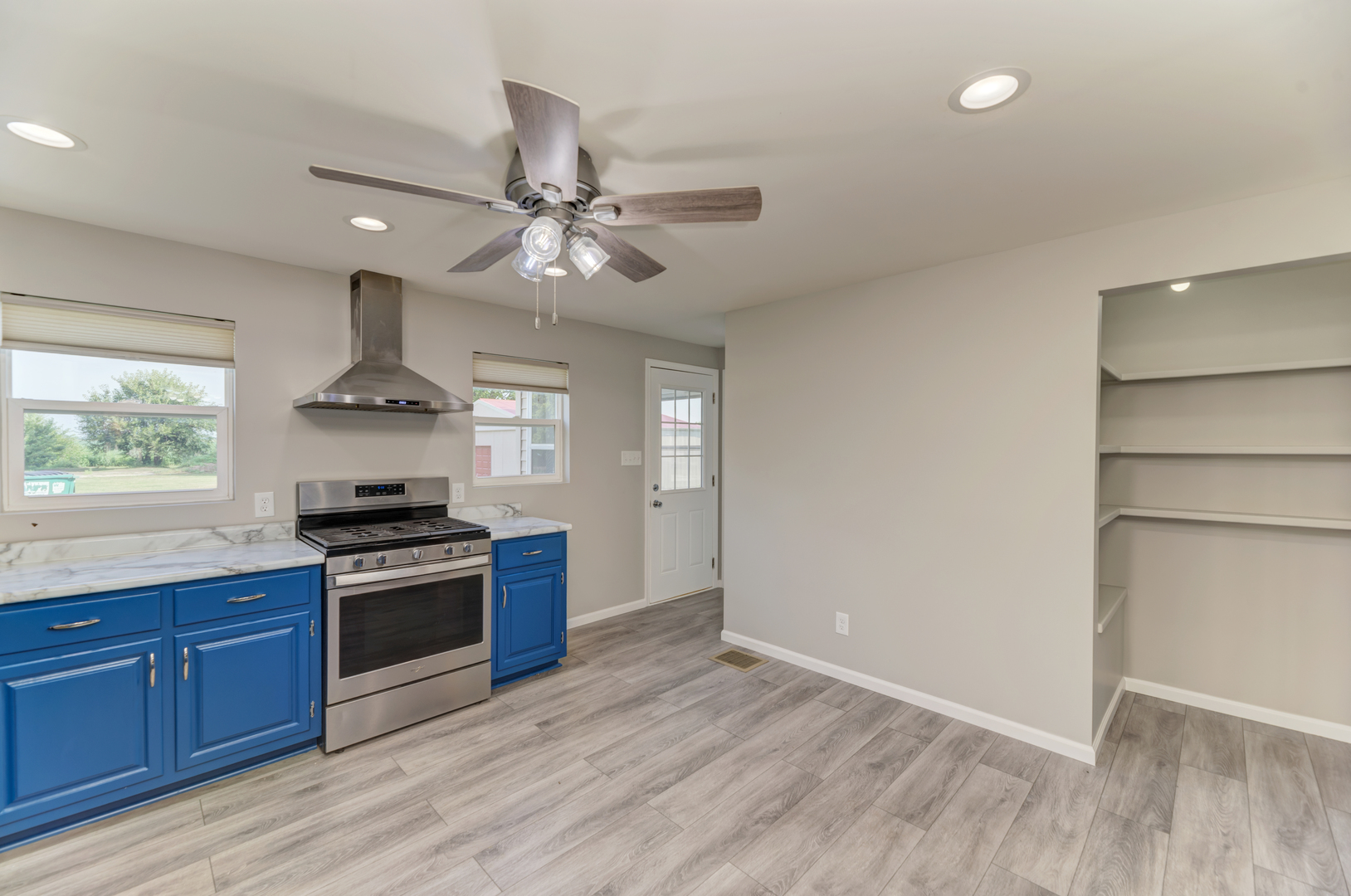 17357 Sedgewick Road Plano, IL 60545 - Photo 12 of 36 a kitchen with granite countertop stainless steel appliances a stove cabinets and wooden floor