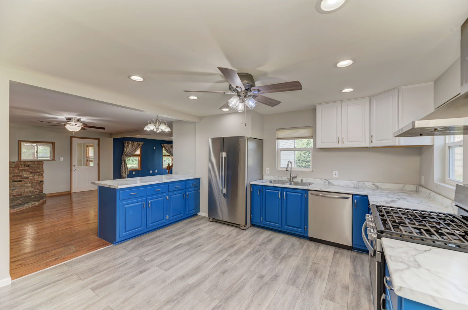 17357 Sedgewick Road Plano, IL 60545 - Photo 14 of 36 a kitchen with stainless steel appliances granite countertop a stove cabinets and wooden floor