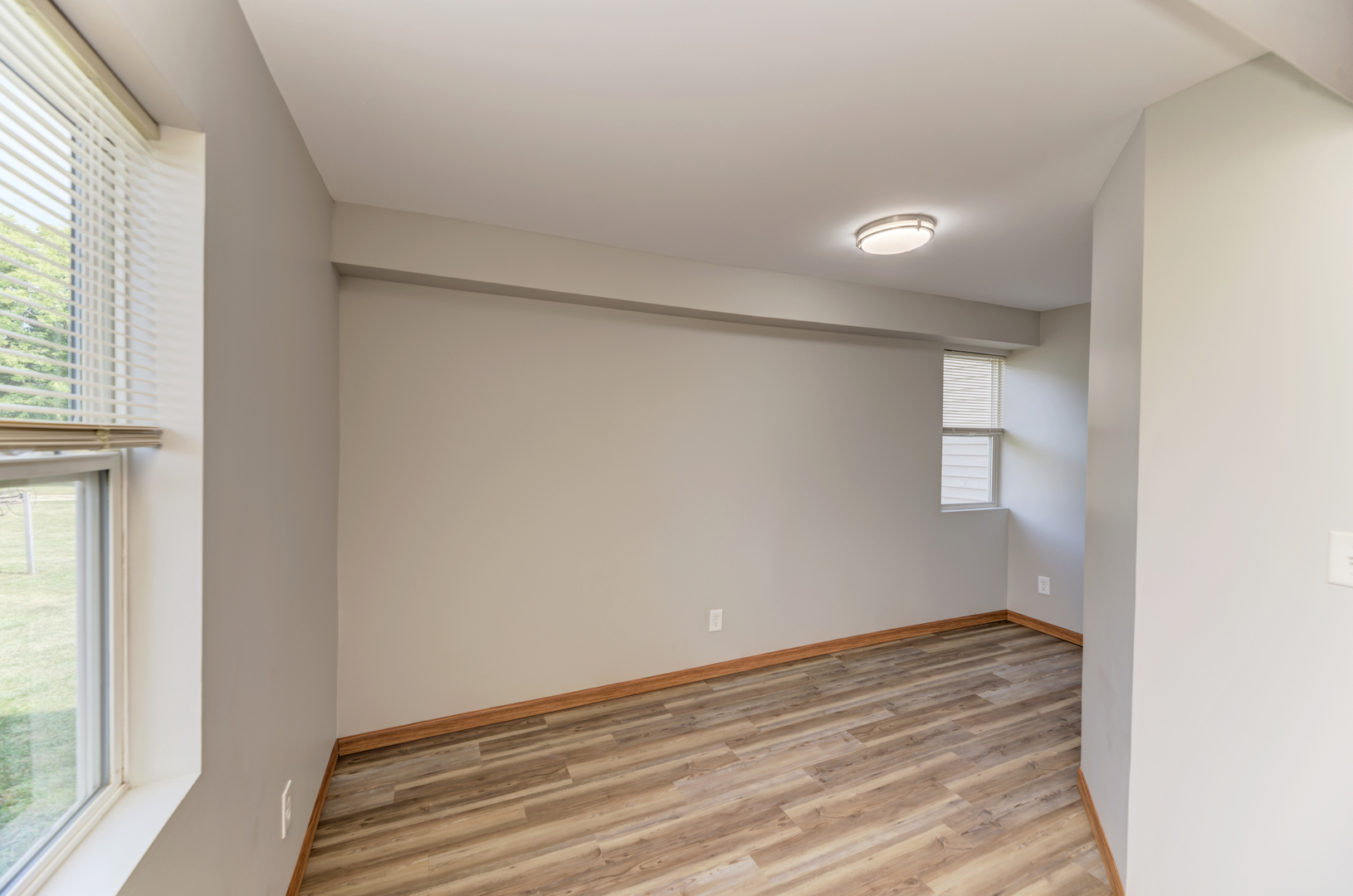 17357 Sedgewick Road Plano, IL 60545 - Photo 19 of 36 an empty room with wooden floor and windows