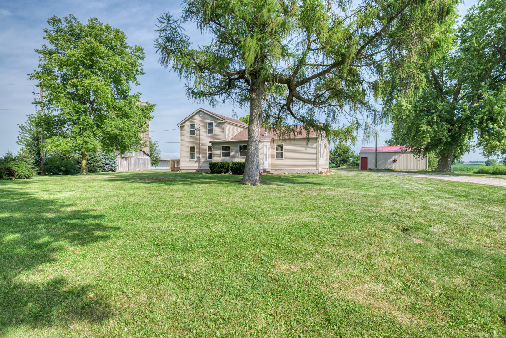 17357 Sedgewick Road Plano, IL 60545 - Photo 2 of 36 a view of a house with a big yard and large trees