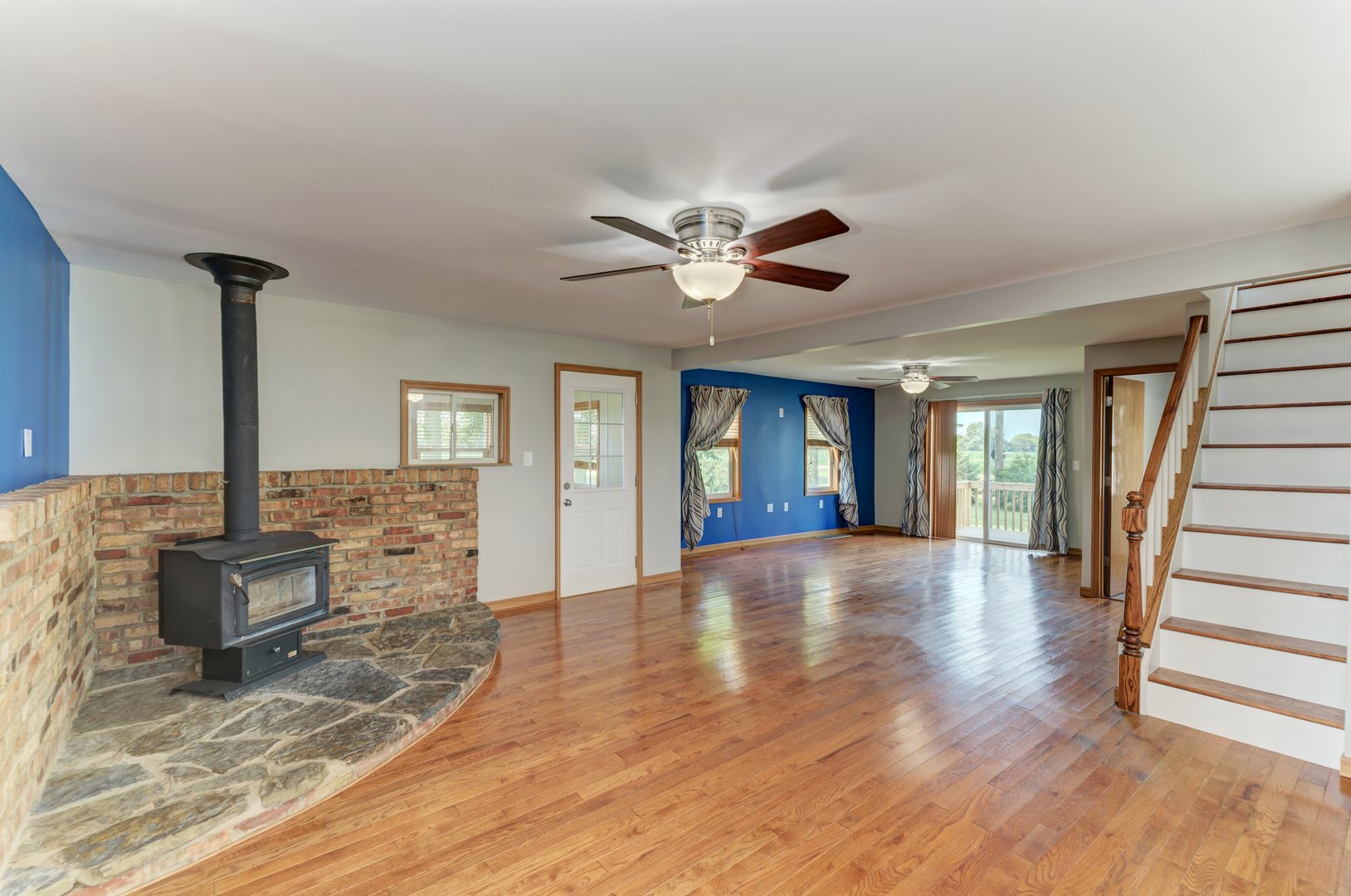 17357 Sedgewick Road Plano, IL 60545 - Photo 7 of 36 a view of an room with wooden floor and a ceiling fan