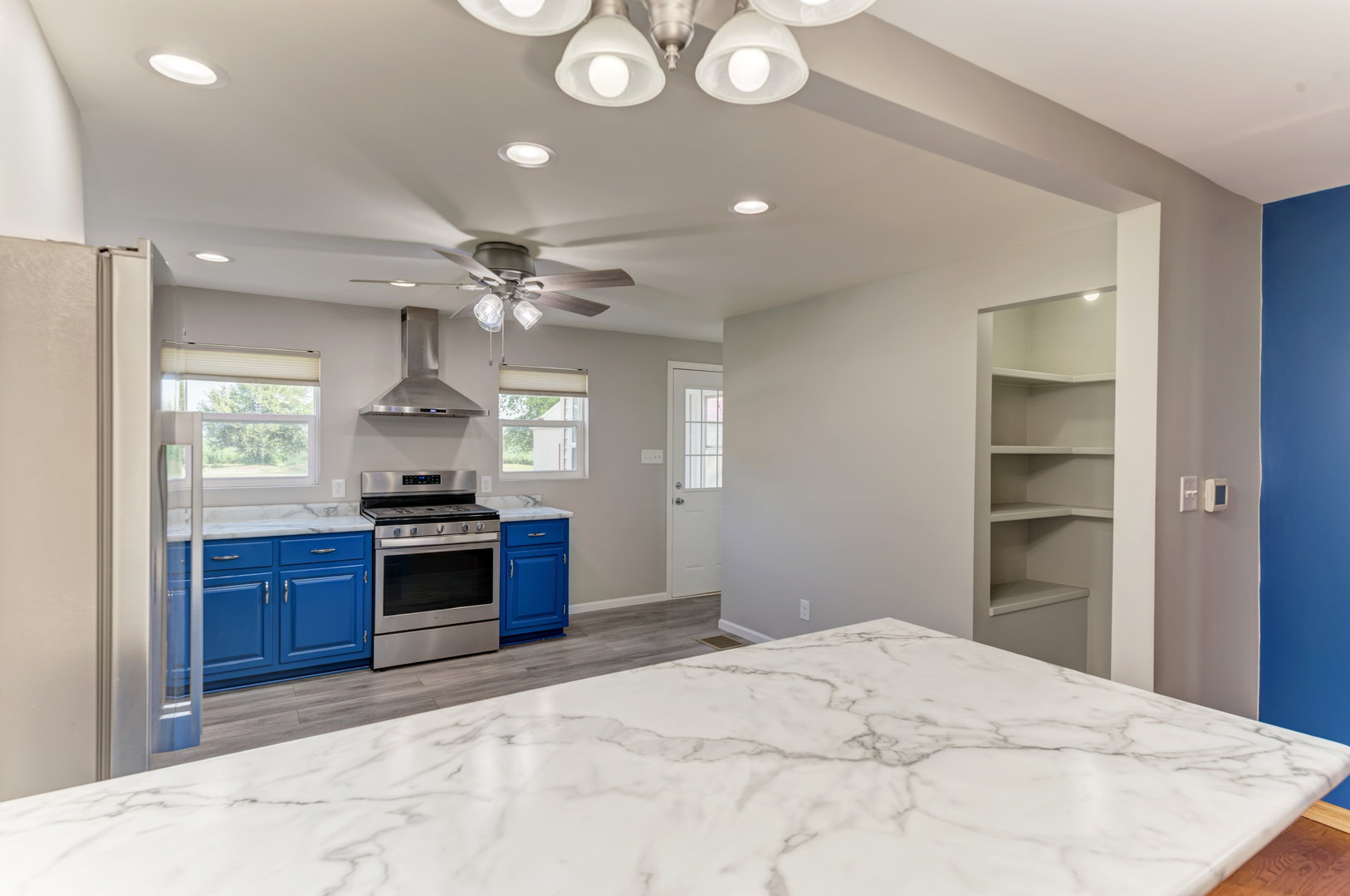 17357 Sedgewick Road Plano, IL 60545 - Photo 10 of 36 a large white kitchen with granite countertop a stove and a sink