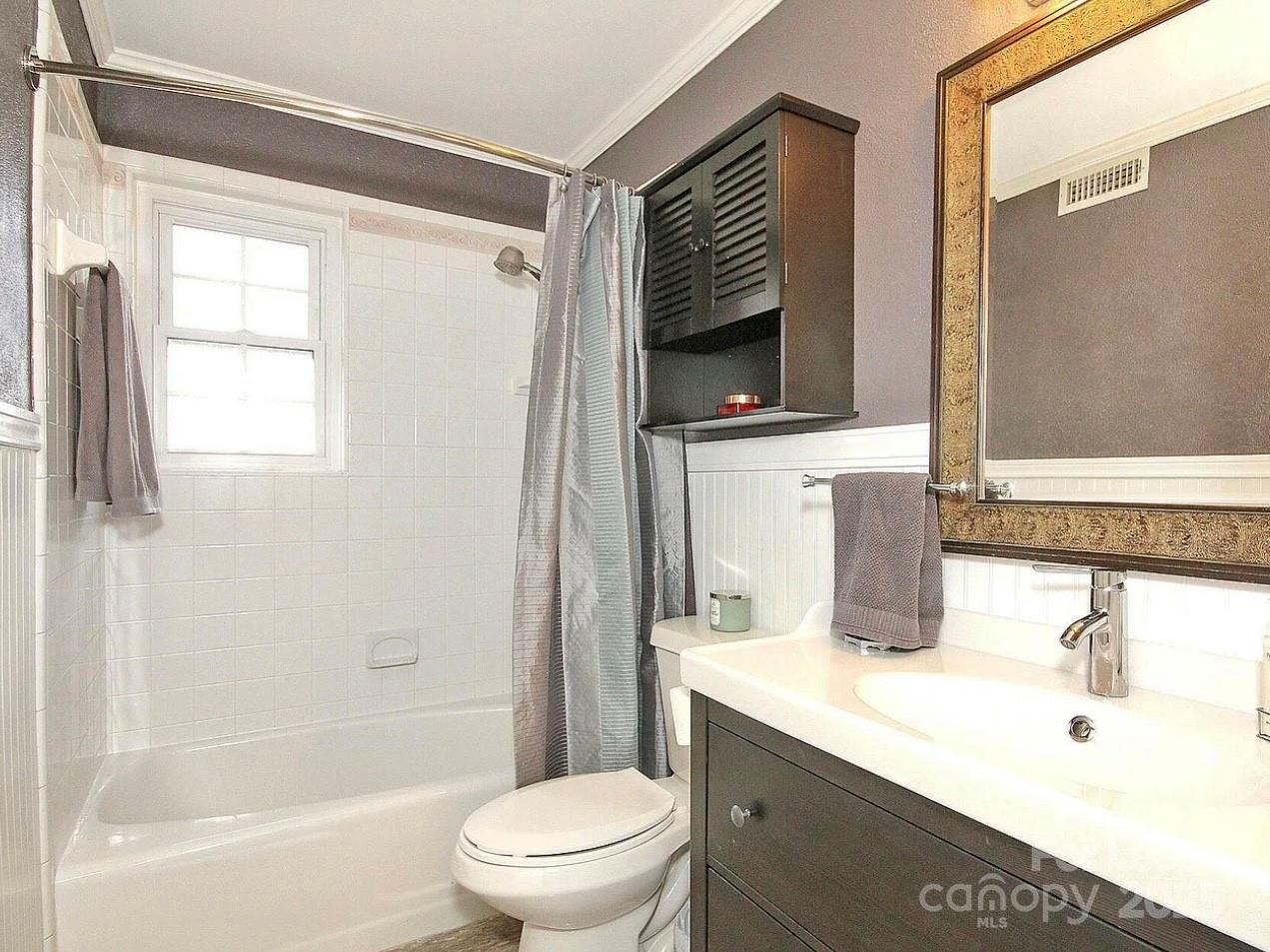 858 McAlway Road, Unit A Charlotte, NC 28211 - Photo 17 of 20 a bathroom with a sink a toilet and shower