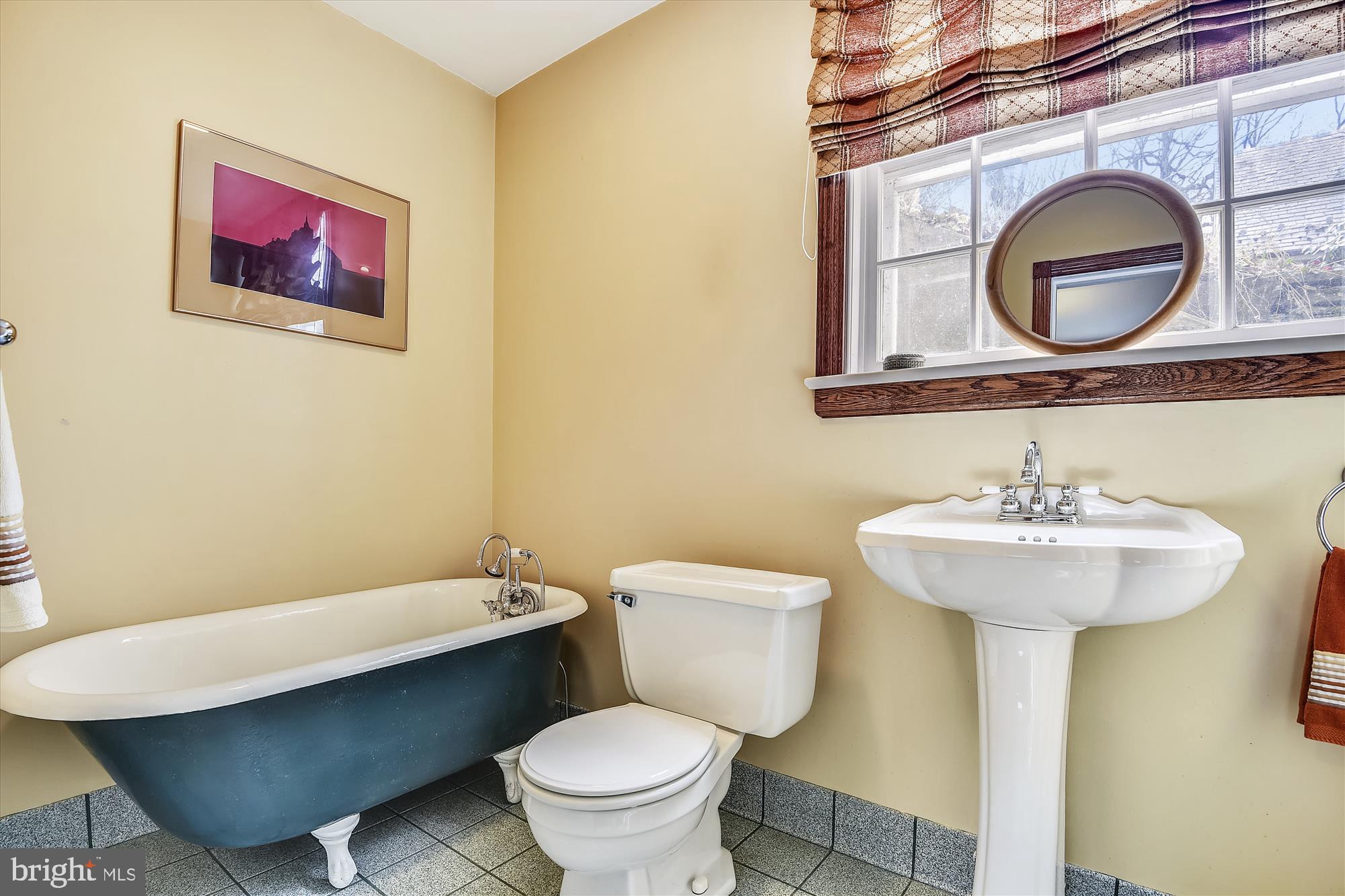 5209 Springlake Way Baltimore, MD 21212 - Photo 20 of 57 a bathroom with a toilet a sink and a mirror