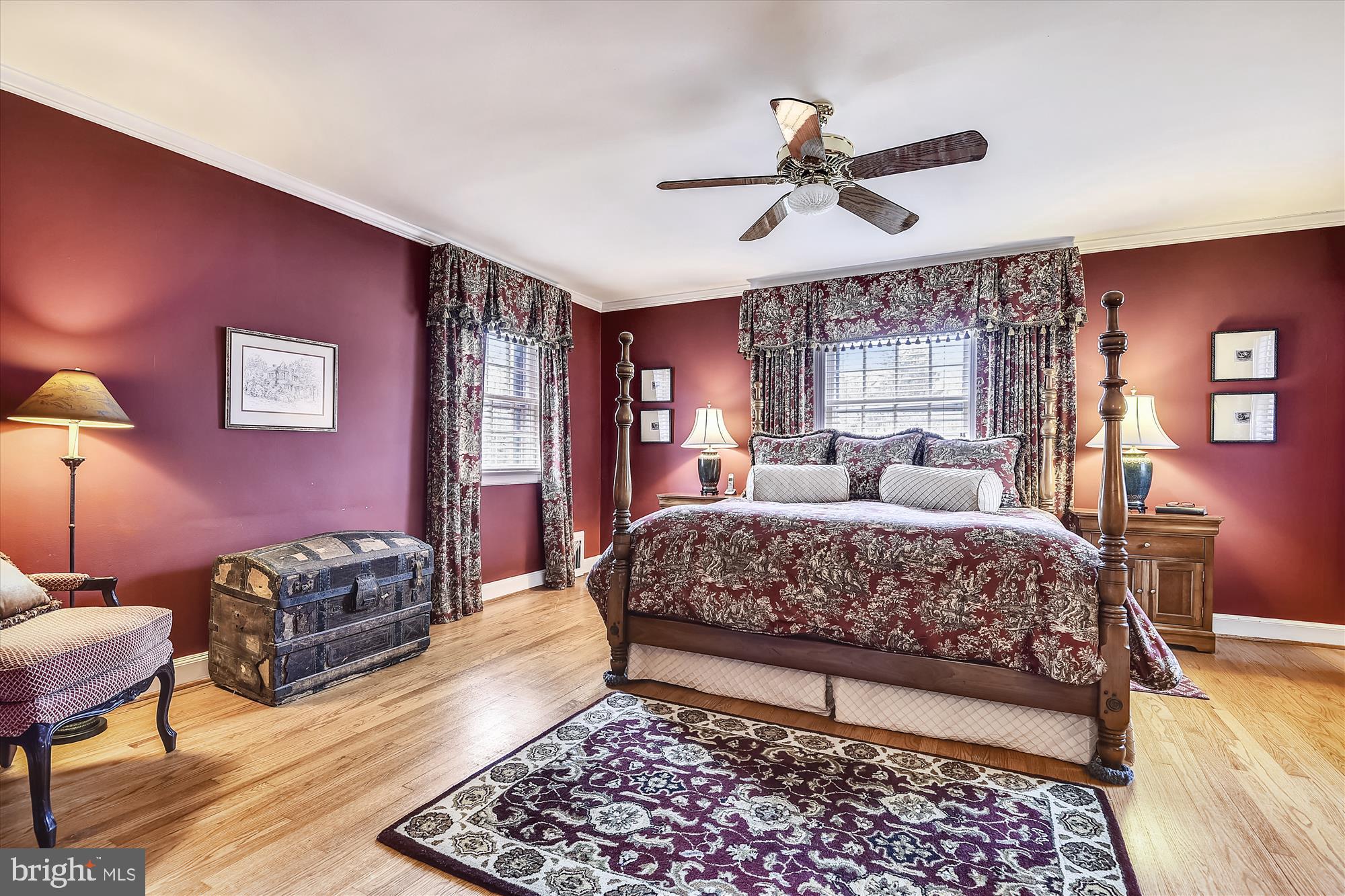 5209 Springlake Way Baltimore, MD 21212 - Photo 23 of 57 a bedroom with a large bed and a chandelier