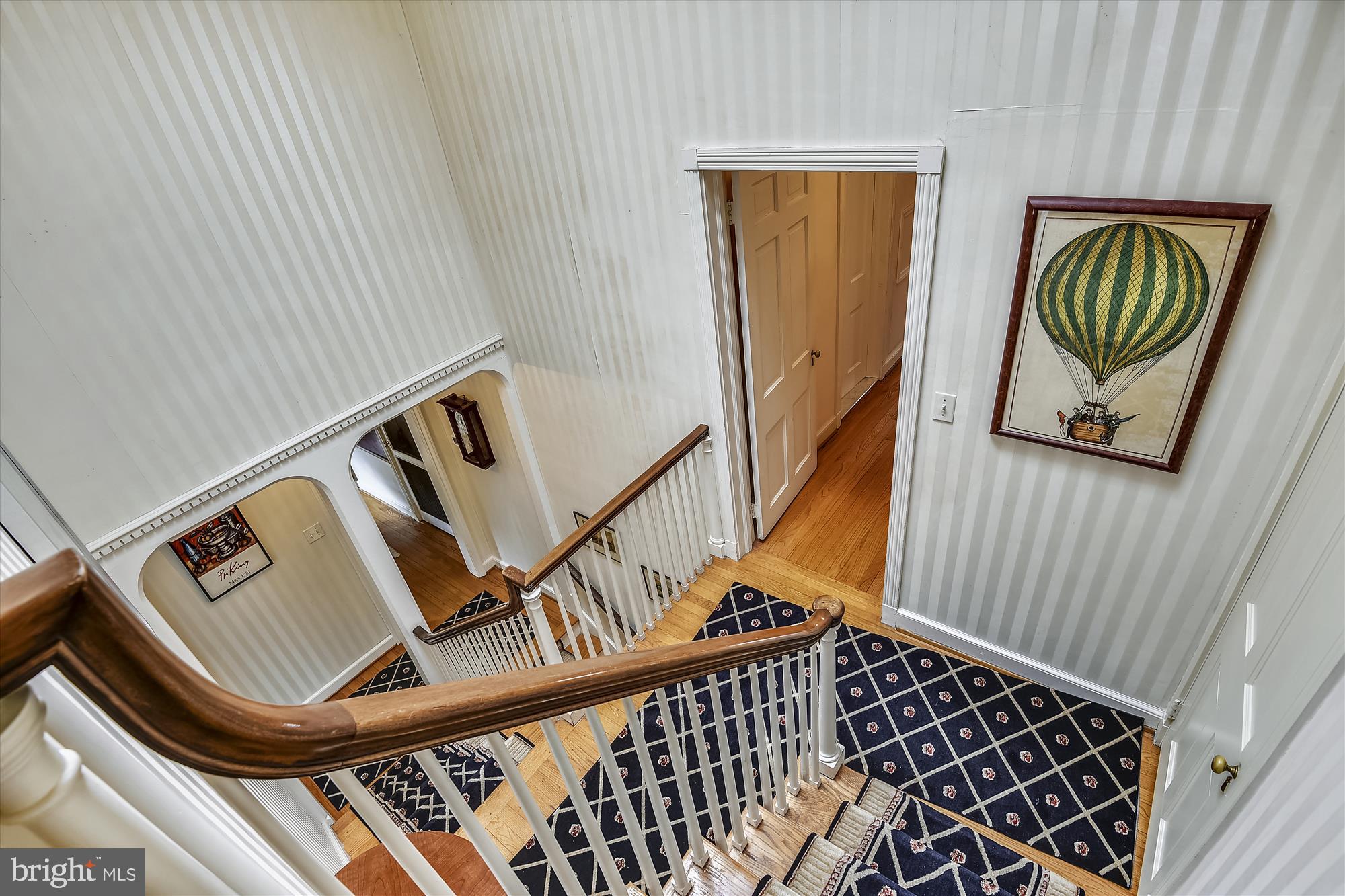 5209 Springlake Way Baltimore, MD 21212 - Photo 27 of 57 a view of staircase with lots of frames on wall and a window