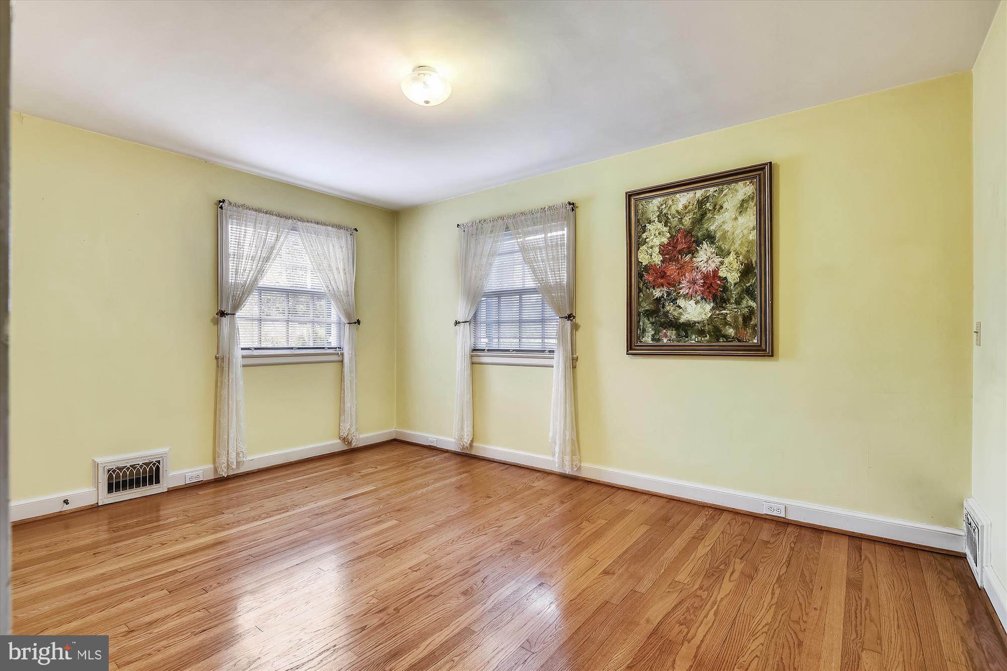 5209 Springlake Way Baltimore, MD 21212 - Photo 28 of 57 a view of an empty room with wooden floor and a window