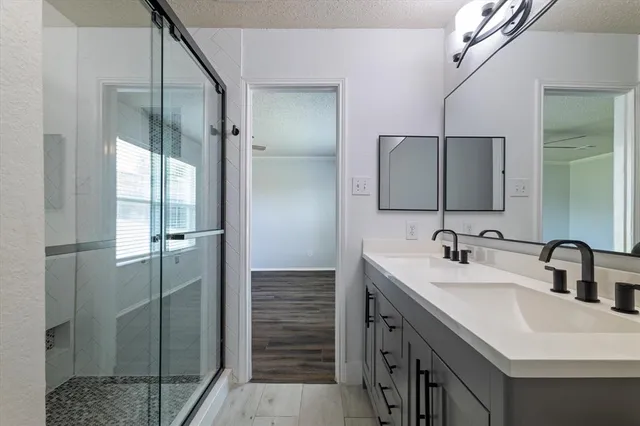 a bathroom with double sink and mirror