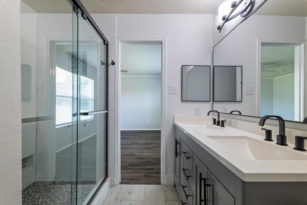 1448 Ridgecrest Drive Little Elm, TX 75068 - Photo 1 of 29 a bathroom with double sink and mirror