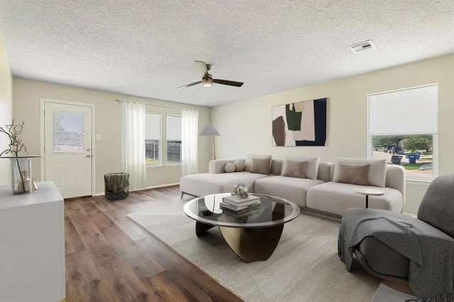 a living room with furniture and a large window