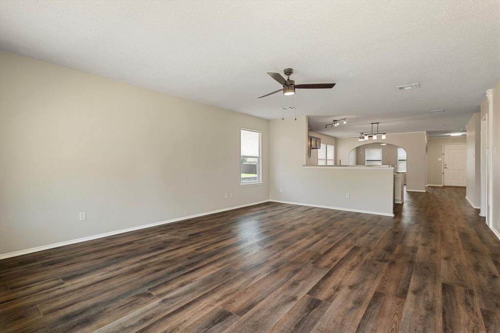 1448 Ridgecrest Drive Little Elm, TX 75068 - Photo 17 of 29 an empty room with wooden floor and windows