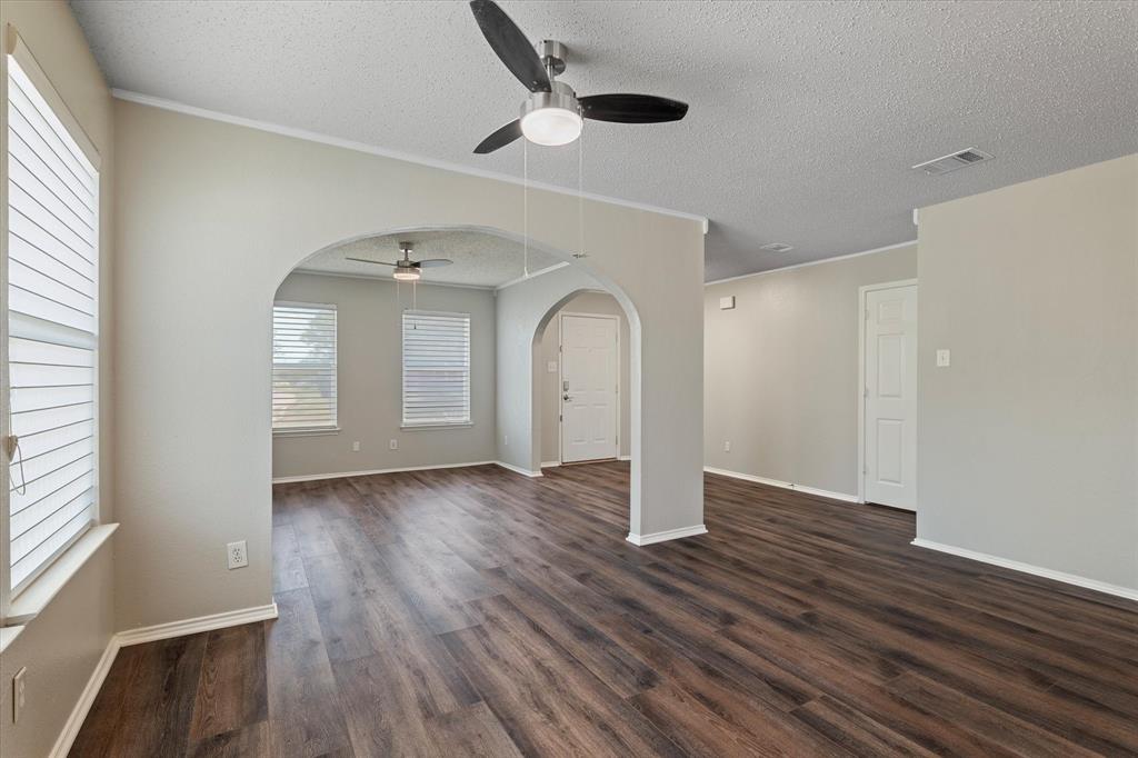 1448 Ridgecrest Drive Little Elm, TX 75068 - Photo 8 of 29 a view of an empty room with wooden floor and a window
