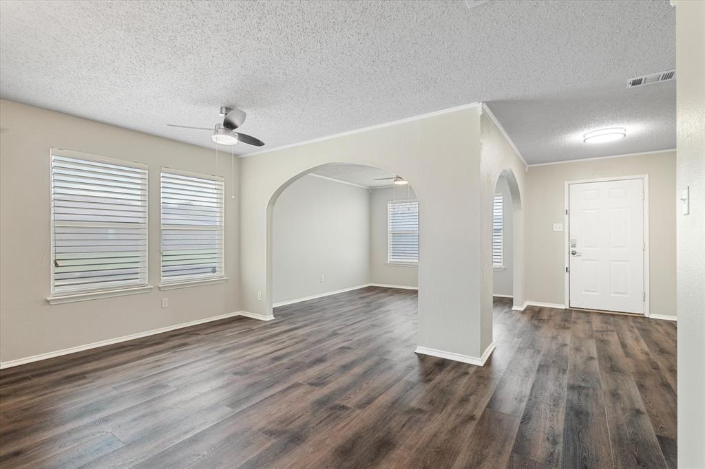 1448 Ridgecrest Drive Little Elm, TX 75068 - Photo 9 of 29 a view of an empty room with wooden floor and a window