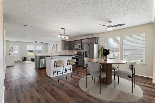 a view of a dining room with furniture and wooden floor