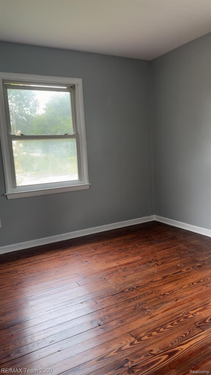 6646 Harding Street Taylor, MI 48180 - Photo 4 of 12 Wood-finish flooring with a satin sheen, complemented by light gray wall paint and white trim