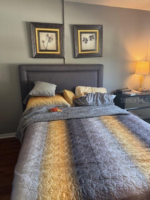 4746 Azalea Drive, Unit 103C New Port Richey, FL 34652 - Photo 13 of 35 a bedroom with bed and painting on the wall