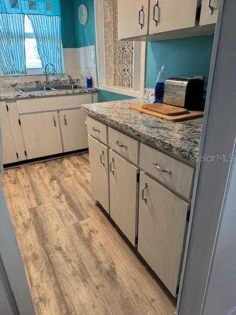 4746 Azalea Drive, Unit 103C New Port Richey, FL 34652 - Photo 14 of 68 a bathroom with a granite countertop sink and a mirror
