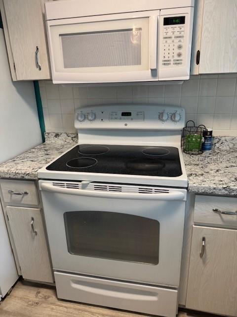 4746 Azalea Drive, Unit 103C New Port Richey, FL 34652 - Photo 16 of 68 a stove top oven sitting inside of a kitchen
