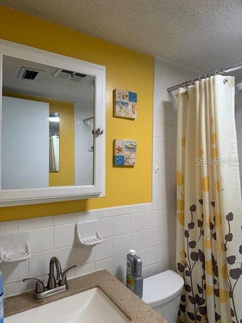 4746 Azalea Drive, Unit 103C New Port Richey, FL 34652 - Photo 17 of 35 a bathroom with a sink a toilet and a mirror