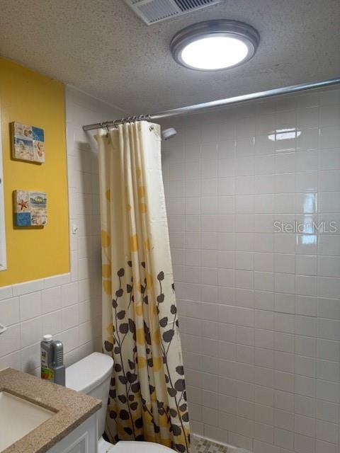 4746 Azalea Drive, Unit 103C New Port Richey, FL 34652 - Photo 18 of 35 a bathroom with a granite countertop sink a mirror and shower