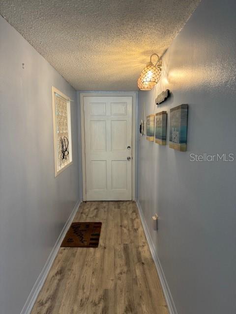 4746 Azalea Drive, Unit 103C New Port Richey, FL 34652 - Photo 18 of 68 a view of a hallway with wooden floor and a large mirror