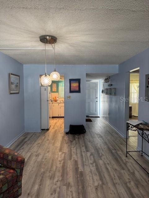 4746 Azalea Drive, Unit 103C New Port Richey, FL 34652 - Photo 2 of 35 a view of a kitchen with a stove wooden floor cabinets and a chandelier