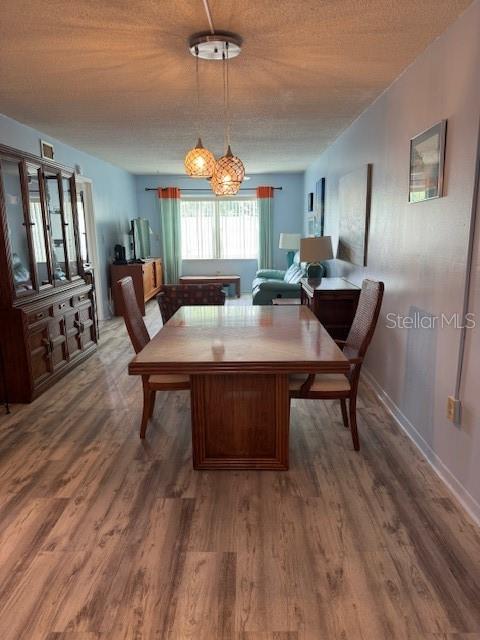 4746 Azalea Drive, Unit 103C New Port Richey, FL 34652 - Photo 2 of 68 a view of a dining room with furniture window and wooden floor