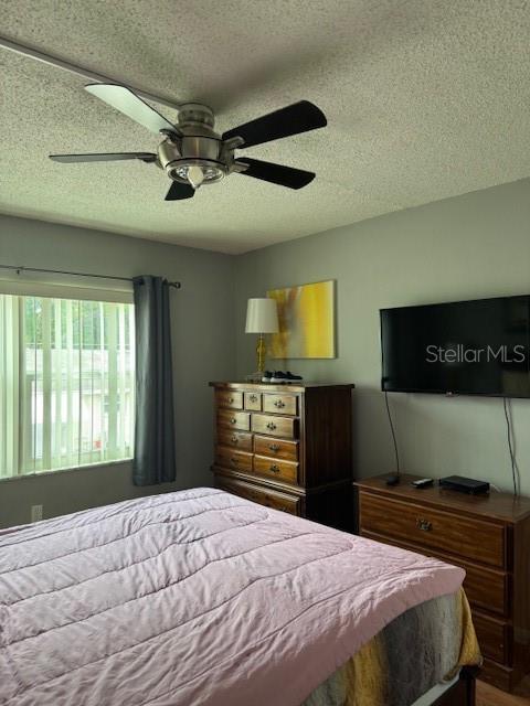 4746 Azalea Drive, Unit 103C New Port Richey, FL 34652 - Photo 21 of 68 a bedroom with a bed and a television
