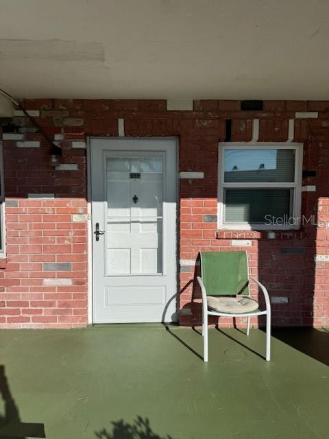 4746 Azalea Drive, Unit 103C New Port Richey, FL 34652 - Photo 24 of 35 a room with furniture and a fireplace