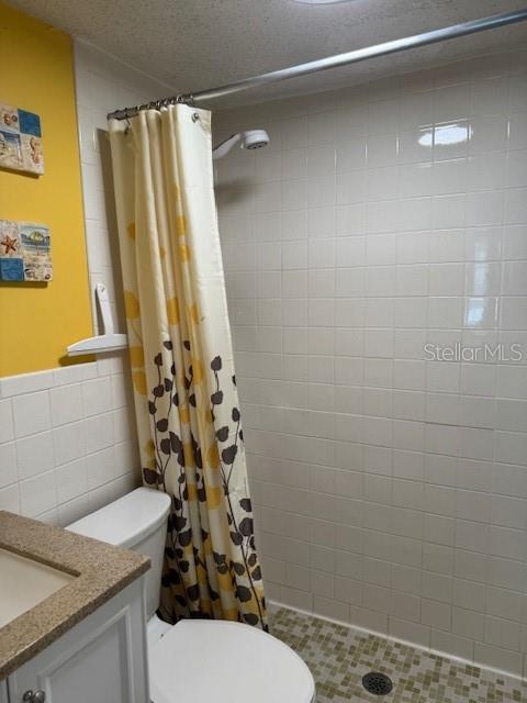 4746 Azalea Drive, Unit 103C New Port Richey, FL 34652 - Photo 27 of 68 a bathroom with a sink a toilet and shower curtain