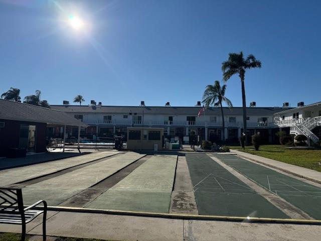 4746 Azalea Drive, Unit 103C New Port Richey, FL 34652 - Photo 30 of 35 a view of a swimming pool with a yard