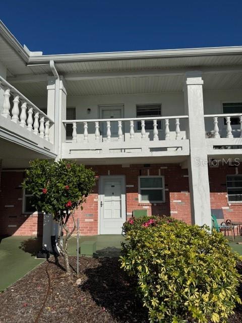 4746 Azalea Drive, Unit 103C New Port Richey, FL 34652 - Photo 34 of 35 a front view of a house with a yard