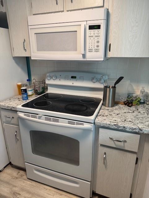 4746 Azalea Drive, Unit 103C New Port Richey, FL 34652 - Photo 4 of 35 a stove top oven sitting inside of a kitchen