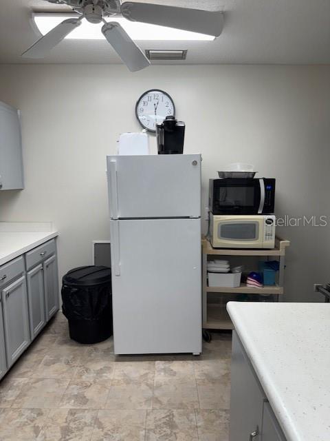 4746 Azalea Drive, Unit 103C New Port Richey, FL 34652 - Photo 56 of 68 a kitchen with a refrigerator and a stove