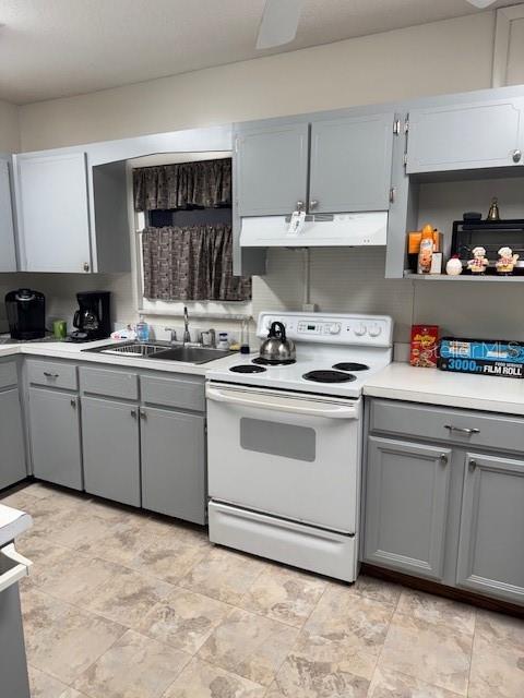 4746 Azalea Drive, Unit 103C New Port Richey, FL 34652 - Photo 57 of 68 a kitchen with white cabinets appliances and a sink