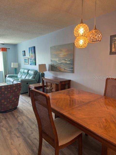 4746 Azalea Drive, Unit 103C New Port Richey, FL 34652 - Photo 8 of 68 a view of a dining room with furniture and wooden floor