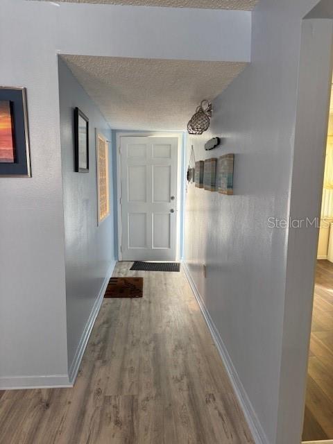 4746 Azalea Drive, Unit 103C New Port Richey, FL 34652 - Photo 10 of 35 a view of a hallway and wooden floor