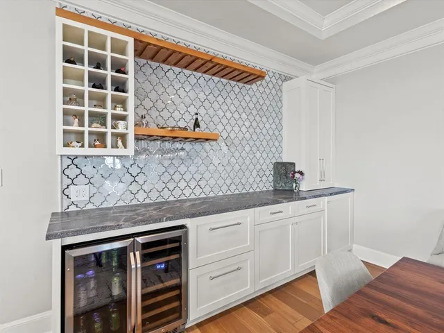 a kitchen with stainless steel appliances cabinets and a table