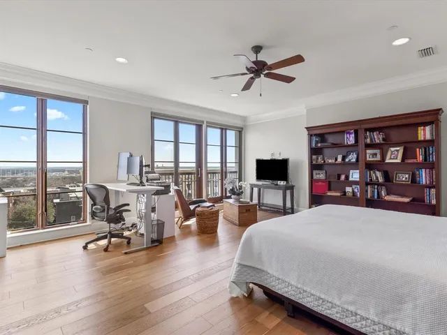 a living room with furniture and floor to ceiling window
