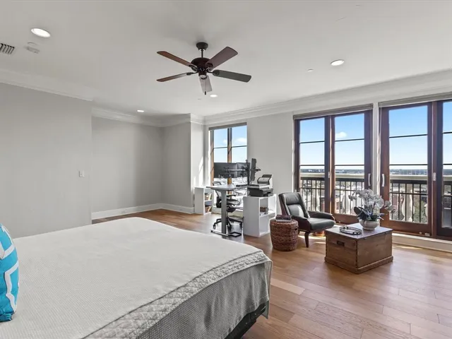 a living room with furniture a flat screen tv and kitchen view