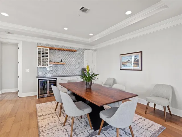 a dining room with furniture and wooden floor