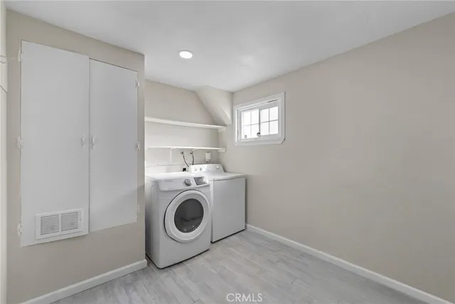 an empty room with floor to ceiling window and fireplace